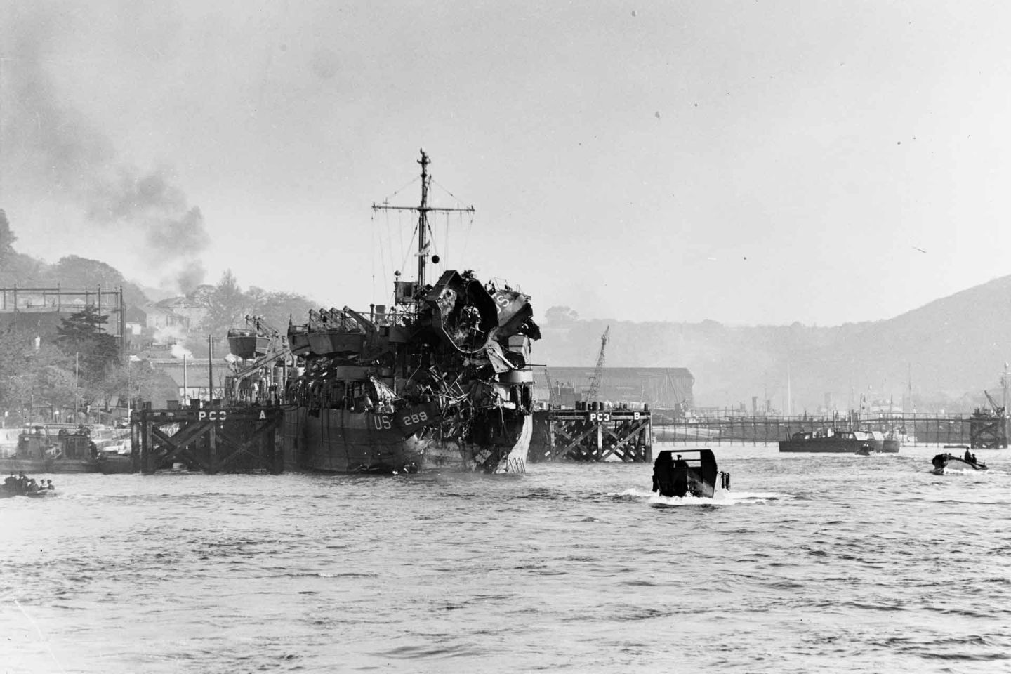 USS LST289 enters Dartmouth Harbor, England, after being torpedoed by German MTBs during invasion rehearsal.