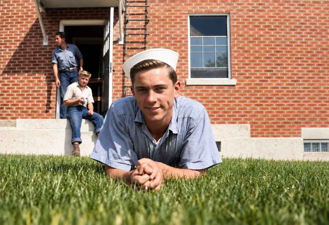 A colourised and restored image of Felton Thomas Fitts laying on a lawn.