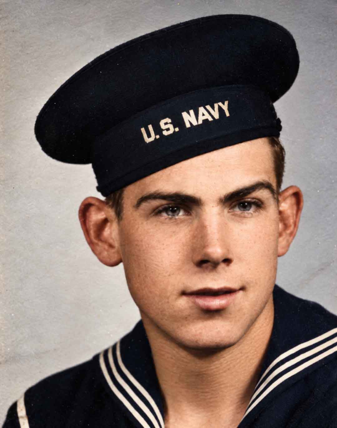 Restored and colourised image of John Lawrence Stanesic in his navy uniform.